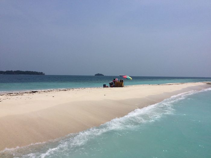 Scenic view of beach against clear sky