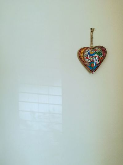 Close-up of heart shape hanging on wall