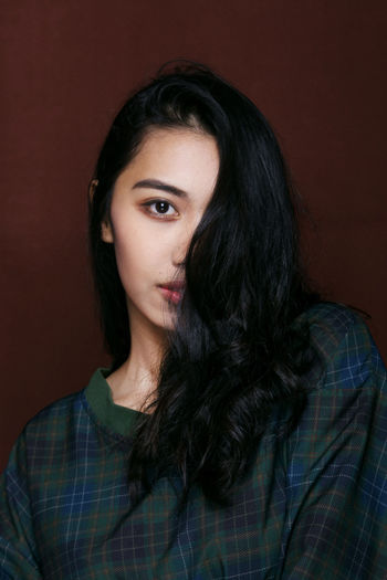 Portrait of young woman with wavy black hair