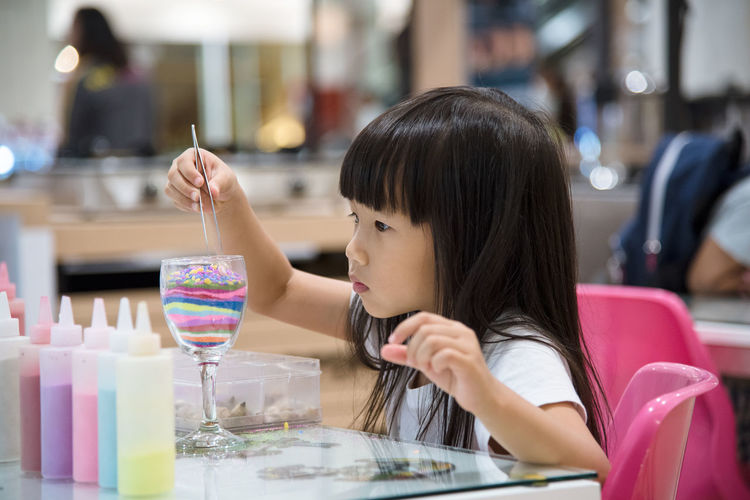 Girl preparing artwork in school