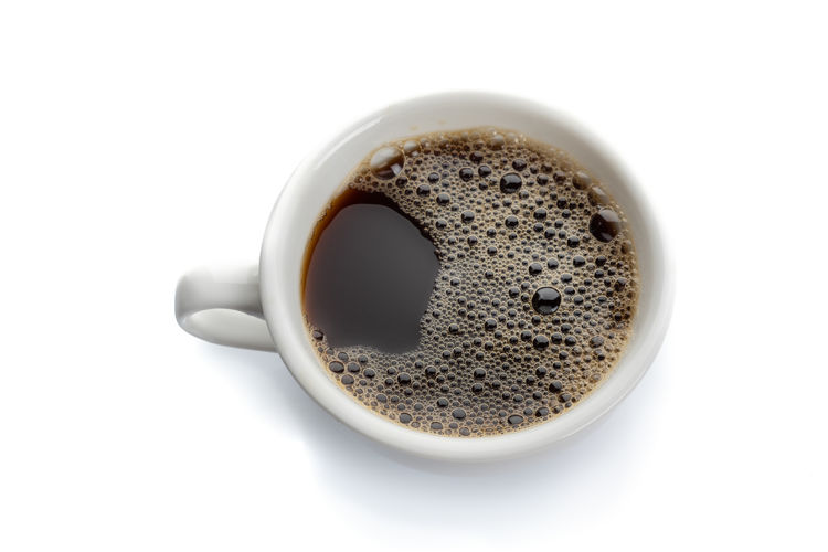 High angle view of coffee cup over white background