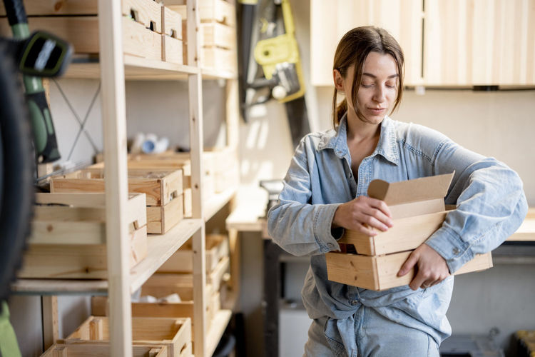Mid adult woman working in box
