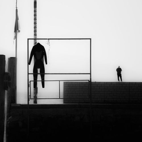 Silhouette man walking against clear sky