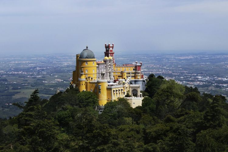 Pena national palace on green mountain against sky