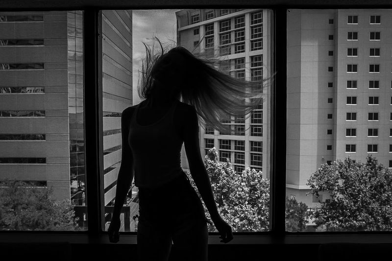 Woman standing against window