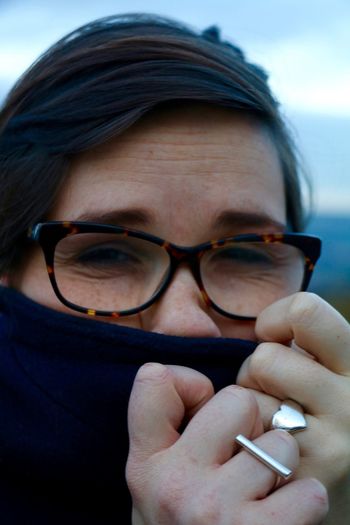 Close-up portrait of woman covering face with fabric
