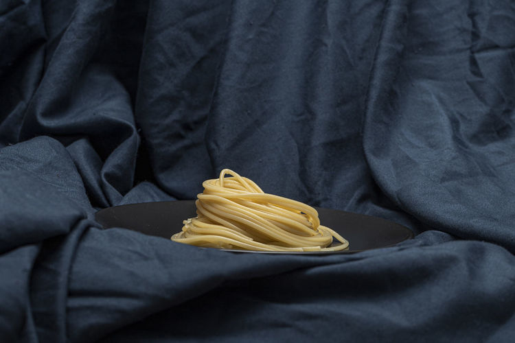 Close-up of yellow pipe on textile