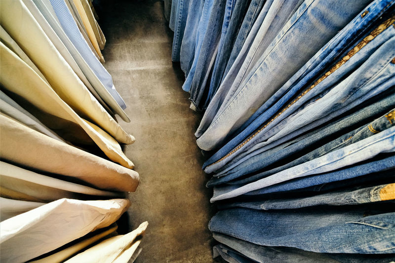 High angle view of jeans and pants hanging in store