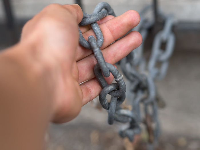 Cropped hand holding chain