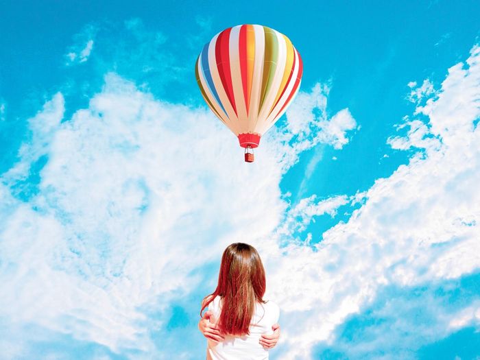 Hot air balloons flying against blue sky