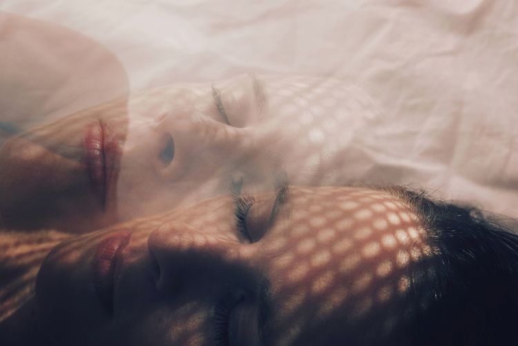 Double exposure image of woman lying on bed