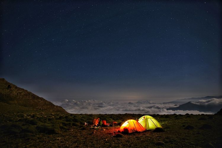 High angle view of tent on field against sky at night