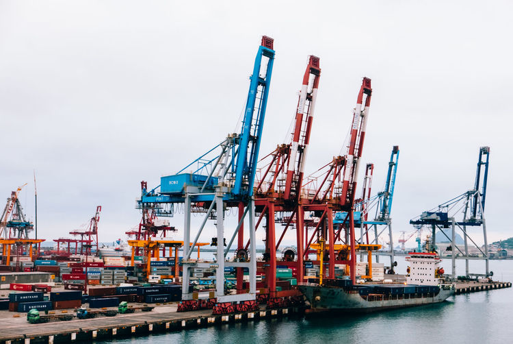 Cranes at commercial dock by river