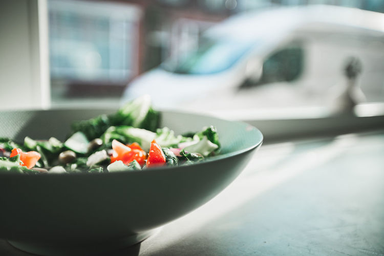 Close-up of salad in bowl on a concrete table