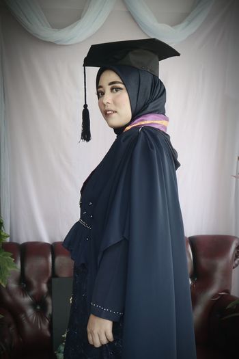 Portrait of woman wearing graduation gown