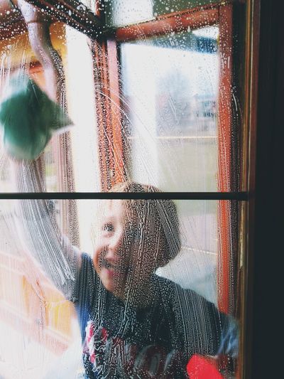 Close-up of boy cleaning window