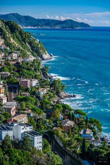 High angle view of townscape by sea against sky