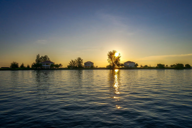 Scenic view of lake against sky during sunset