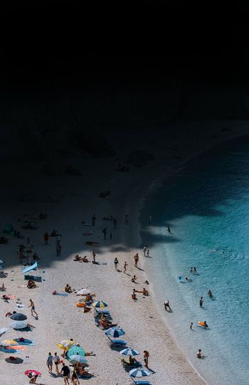 HIGH ANGLE VIEW OF PEOPLE ENJOYING ON BEACH
