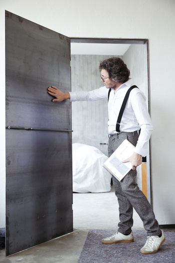 Architect checking steel door at construction site