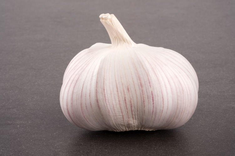 Close-up of garlic on white table