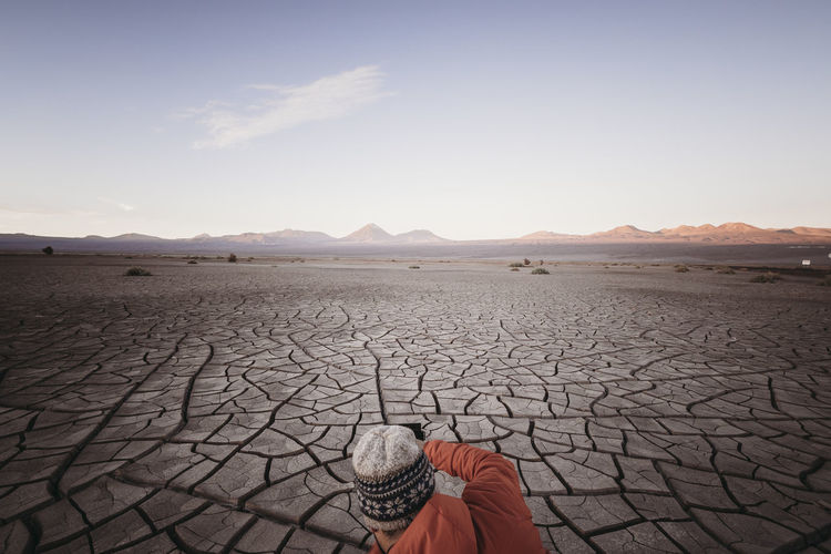 Photographer shooting erosion cracks in atacama desert