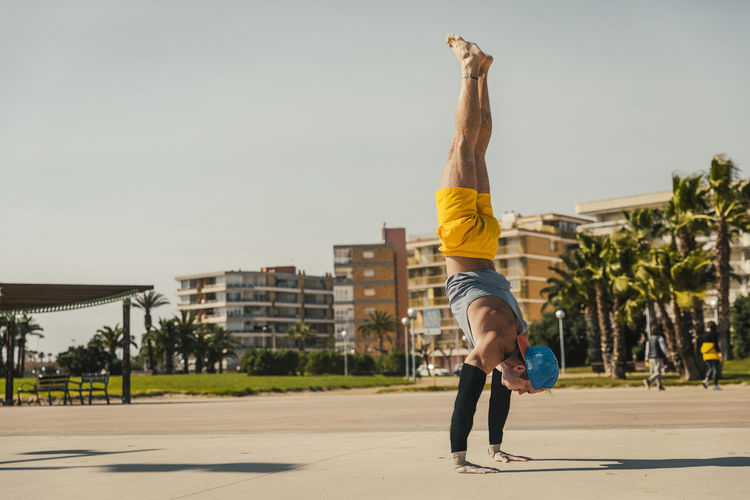 Male gymnastic performing handstand at park