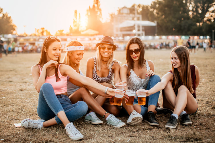 Friends cheering with beer at the music festival