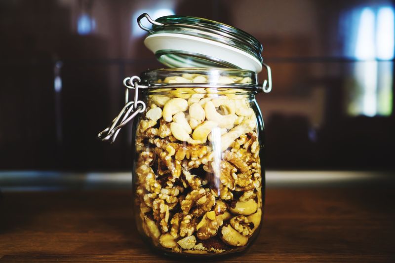 Close-up of dry fruits in glass jar on table at home