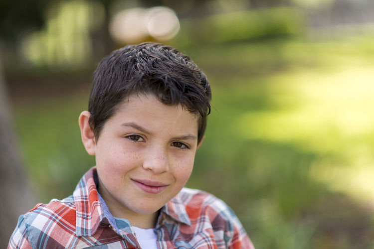 Portrait of boy outdoors in sunny day