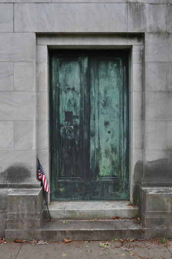 Locked door on an abandoned mausoleum in a cemetery