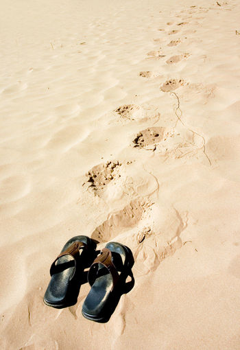 High angle view of shoes on sand at beach