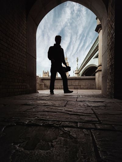Rear view of silhouette man standing in city