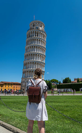 Rear view of woman looking at leaning tower of pisa