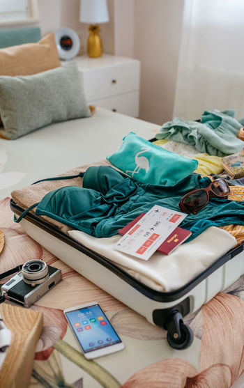 Open woman suitcase prepared for vacation