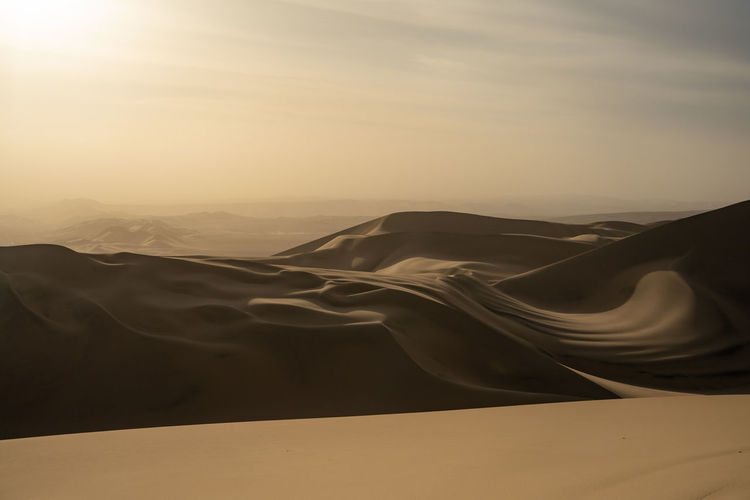 Scenic view of desert against sky during sunset in huacachina, peru