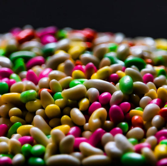 Close-up of multi colored candies against black background