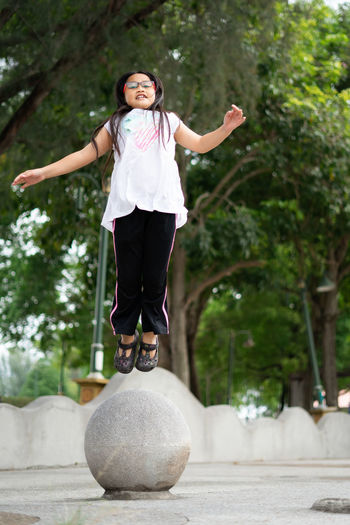 Full length of a smiling girl jumping.
