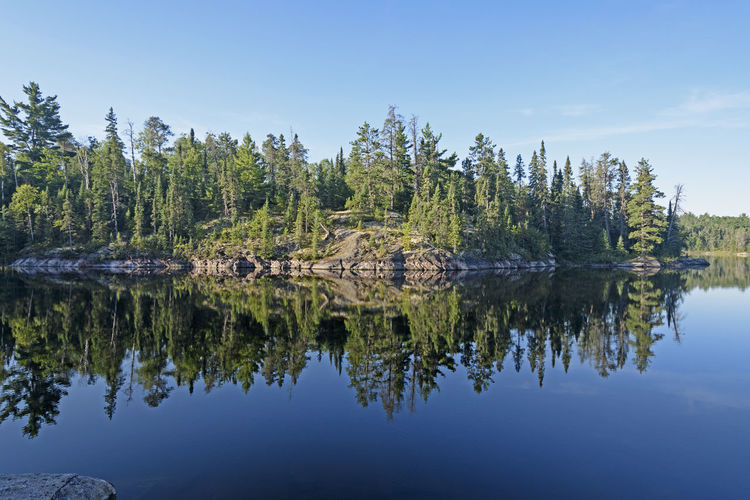 Morning reflections in canoe country on sidney lake of quetico provincial park in ontarioovincial