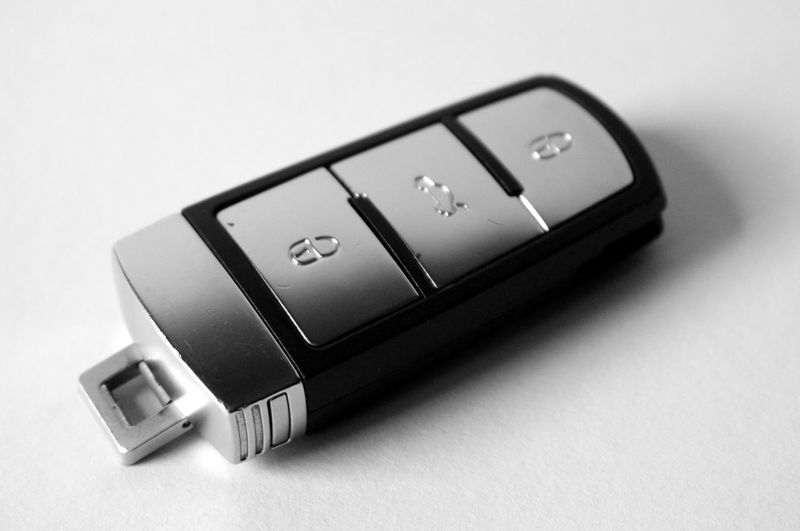 Close-up of car key over white background