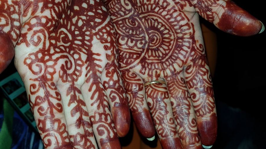 Close-up of woman hands with henna tattoo