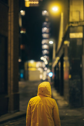 Rear view of woman standing in city