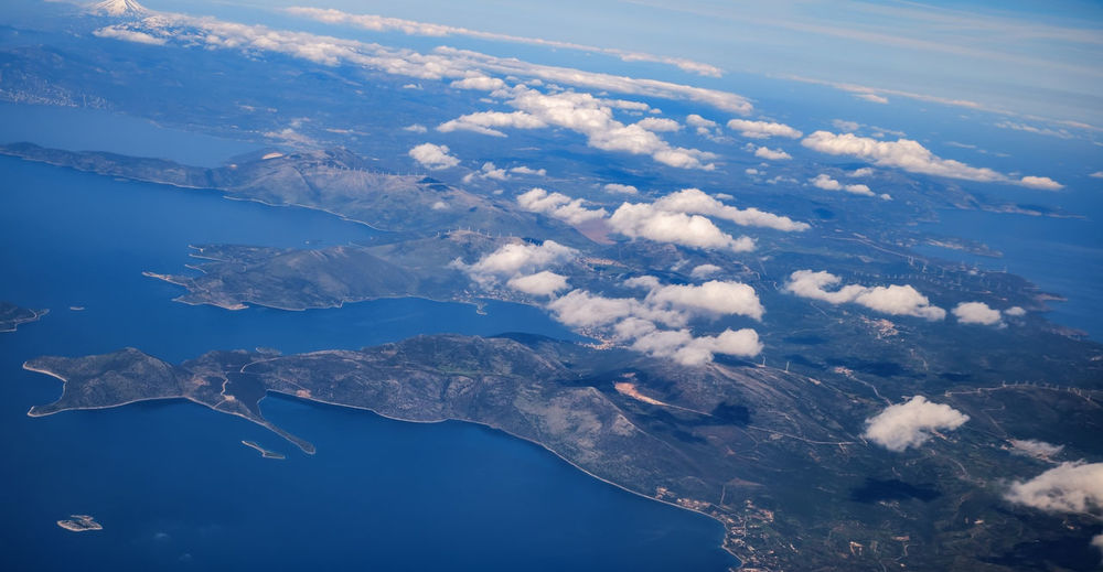 Aerial view of sea and landscape against sky