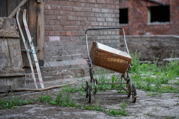 Old antique baby carriage on a farm