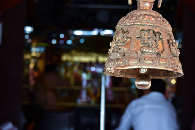 Close-up of illuminated lighting equipment hanging at night