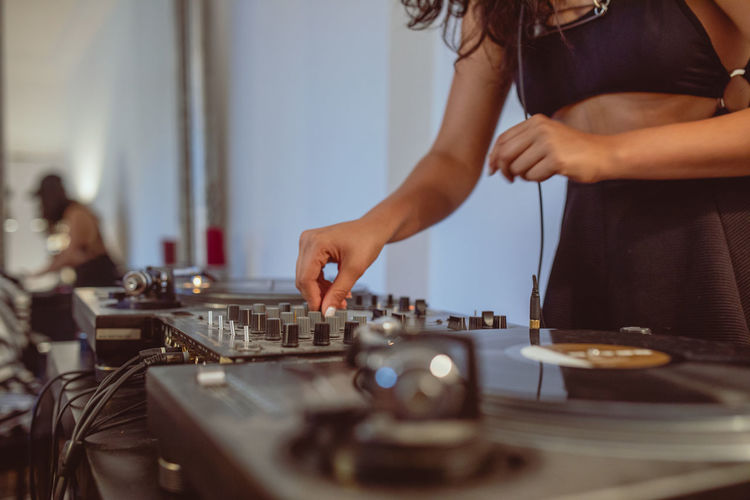 Fashionable young woman playing music at home