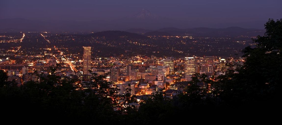 High angle view of illuminated city buildings at night