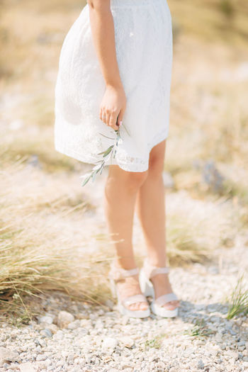 Low section of woman standing on ground