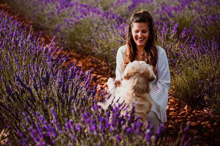 Woman with dog on lavender field