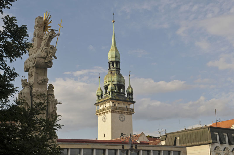 Low angle view of statue against buildings